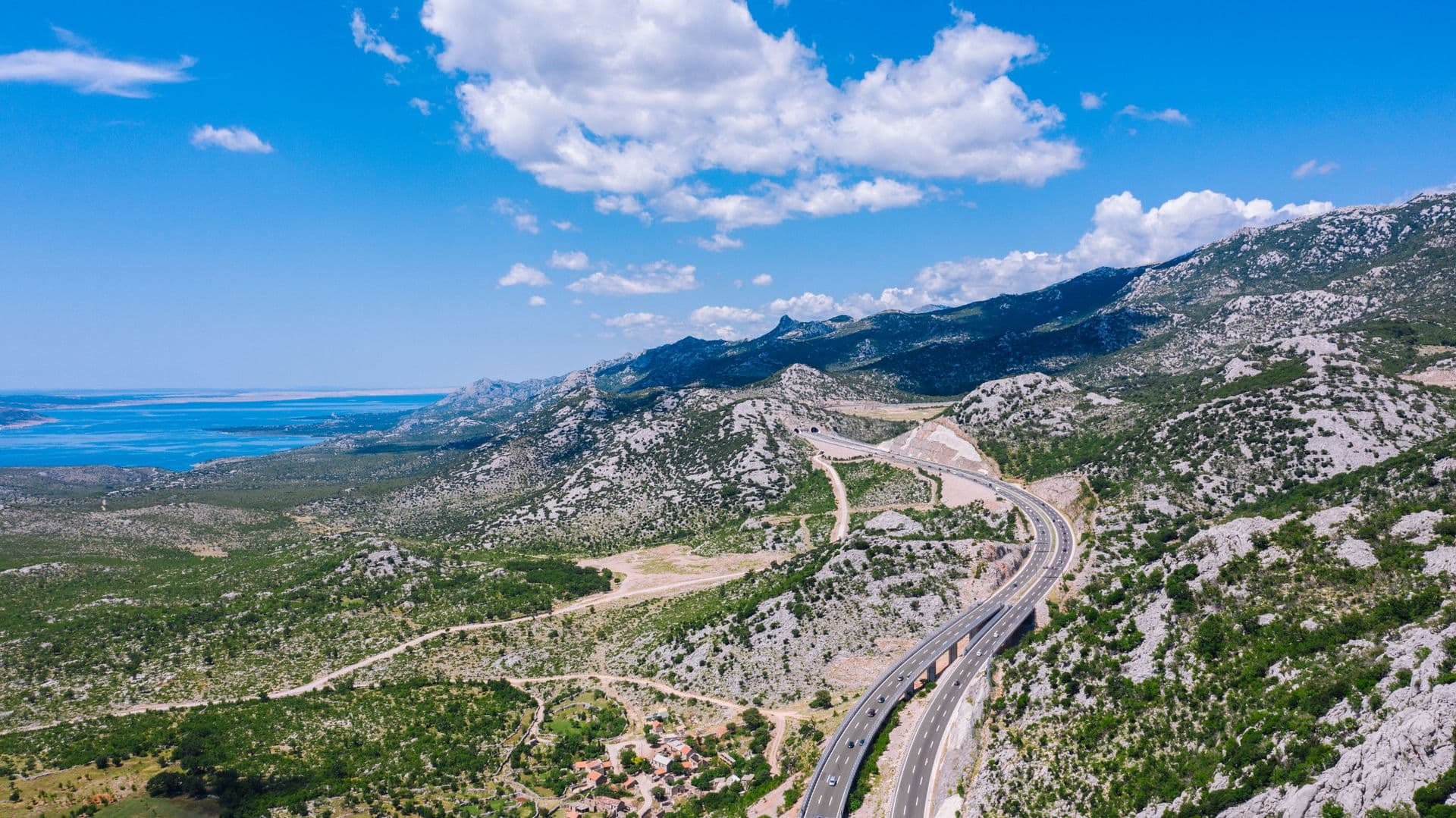 The A1 motorway curving through the Velebit mountains toward the sea, from above