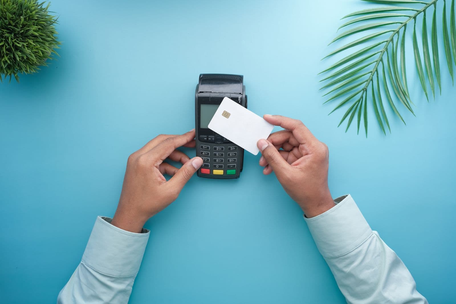 A bank card held over a payment terminal