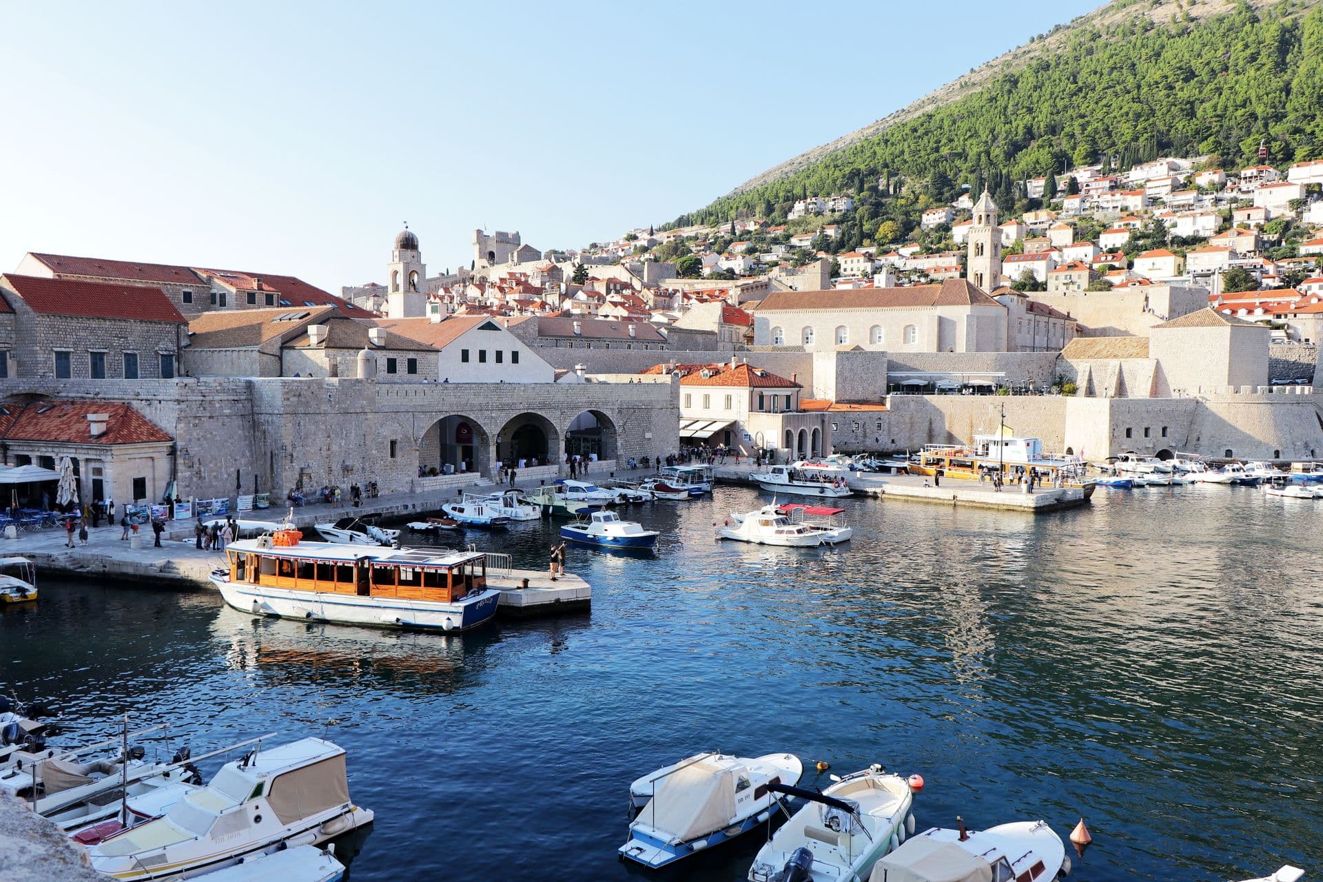 Dubrovnik's old harbour, fishing boats moored below the city walls