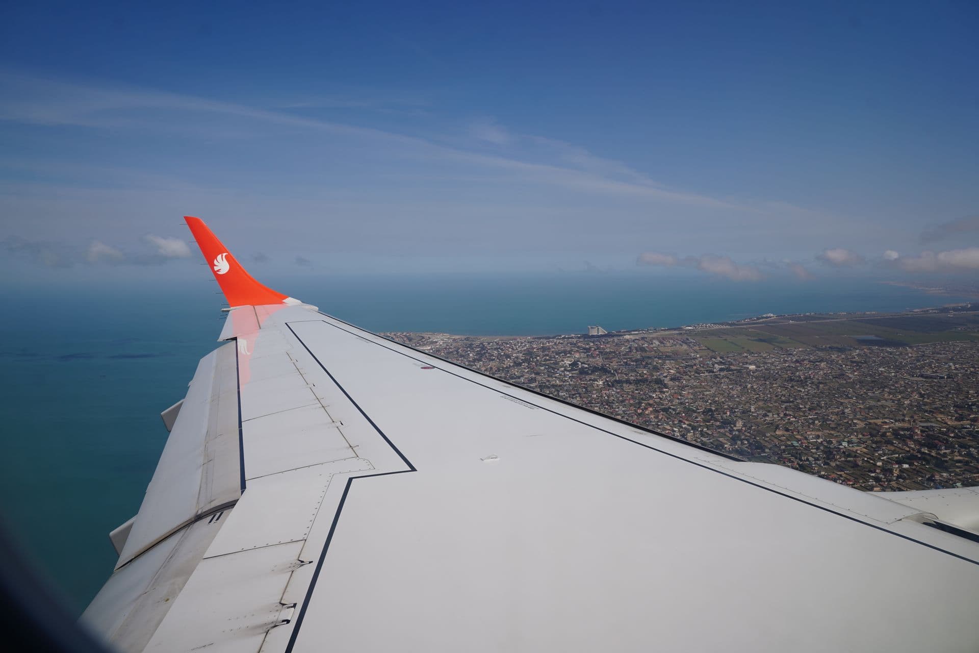 A passenger jet on approach above the Adriatic coastline