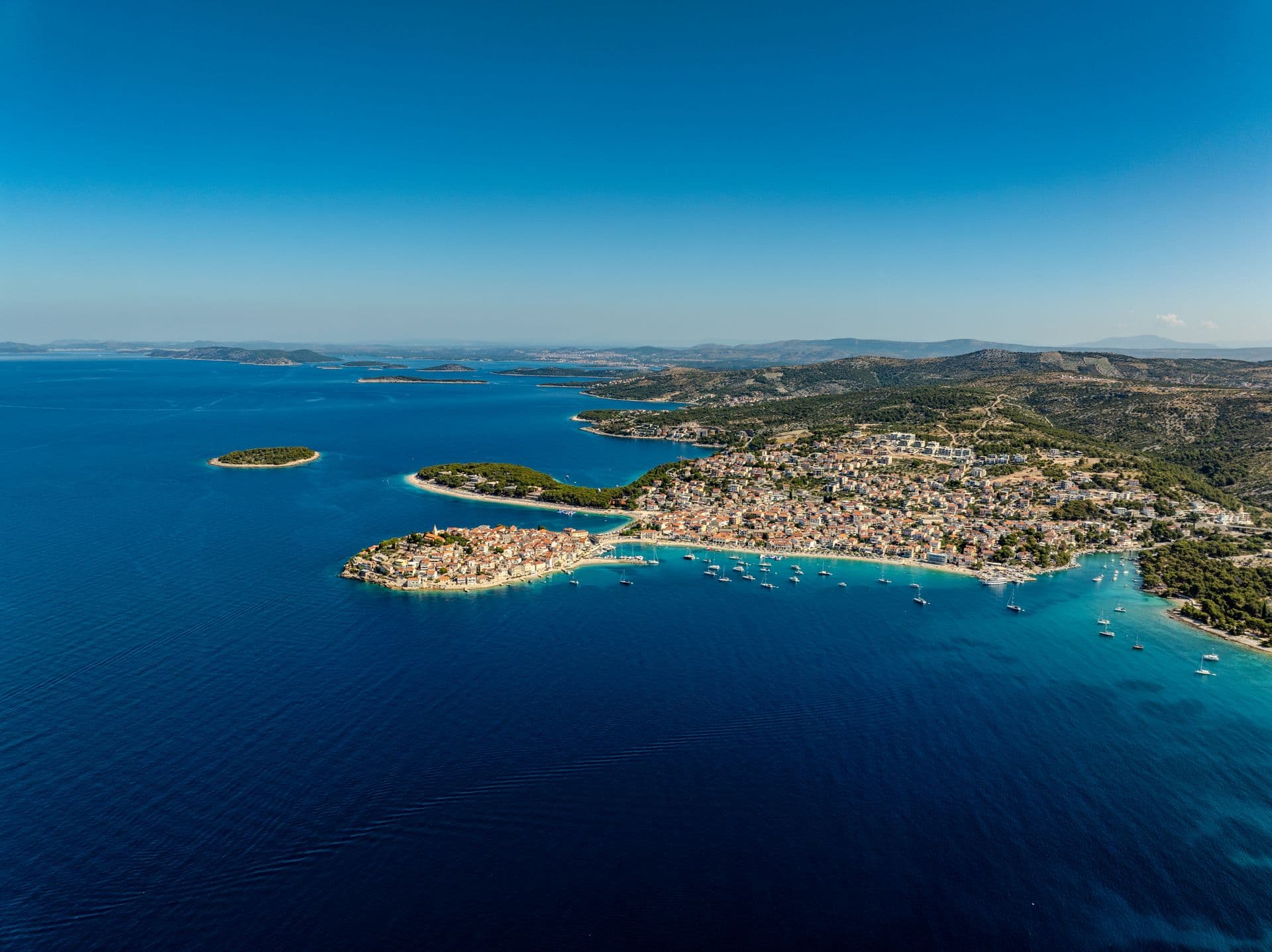 Primosten's old town on its peninsula in the blue Adriatic, from the air