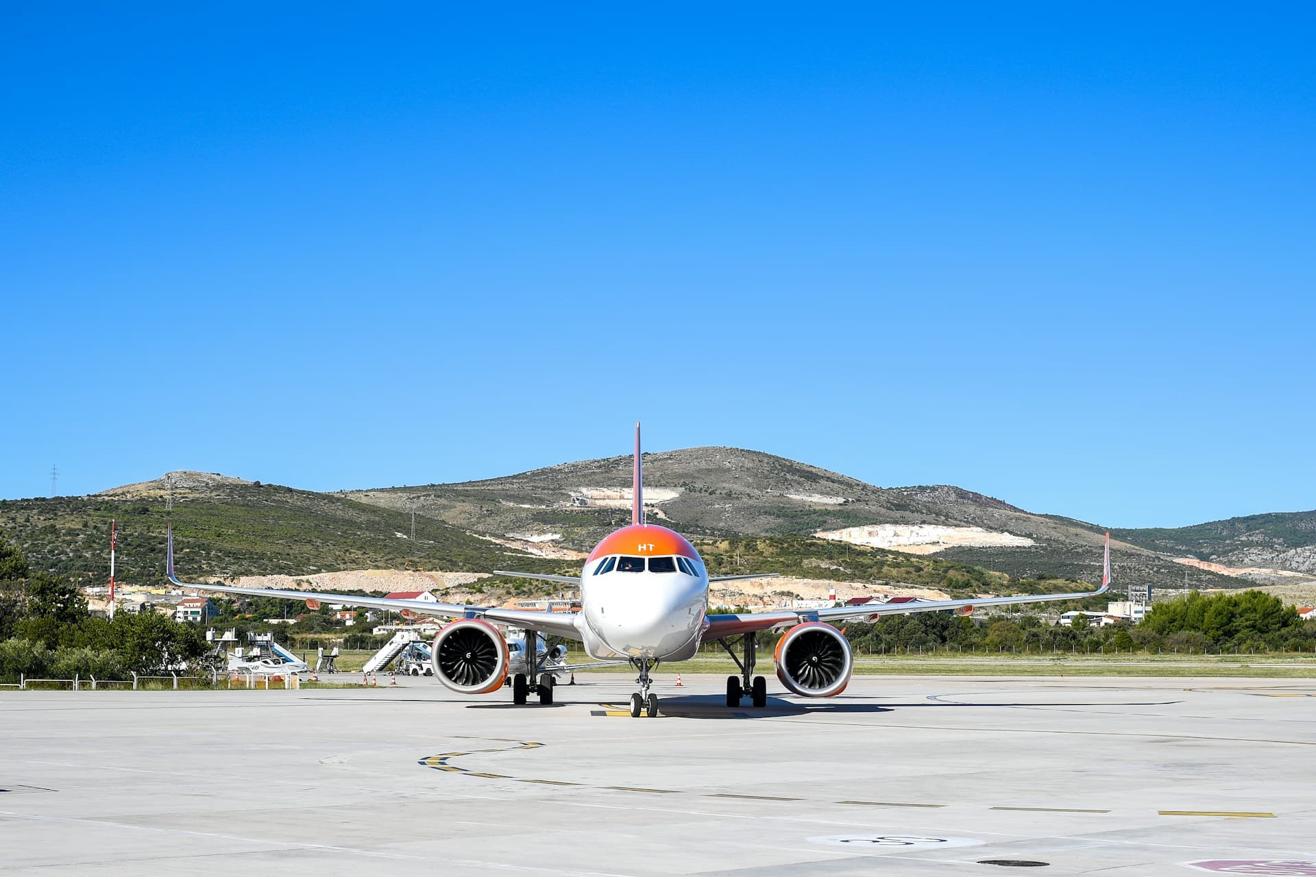 A jet on the Split Airport apron with the Kastela hills behind