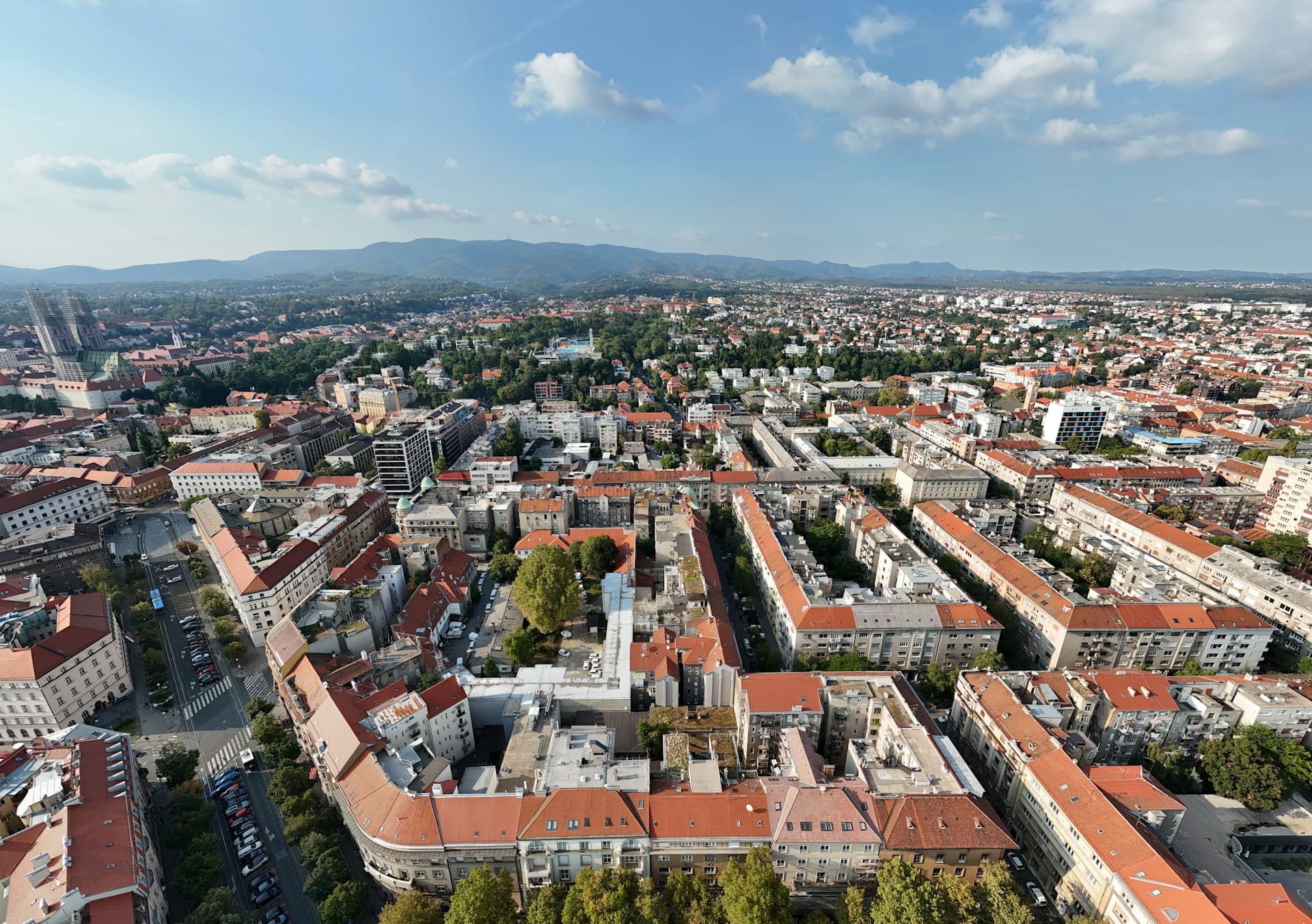Zagreb's rooftops and spires from above, Medvednica hills behind